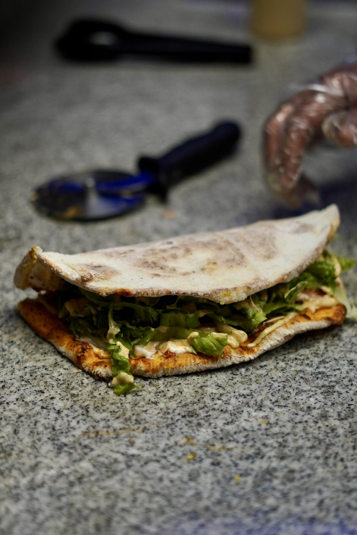 A freshly folded makloub showing its filling